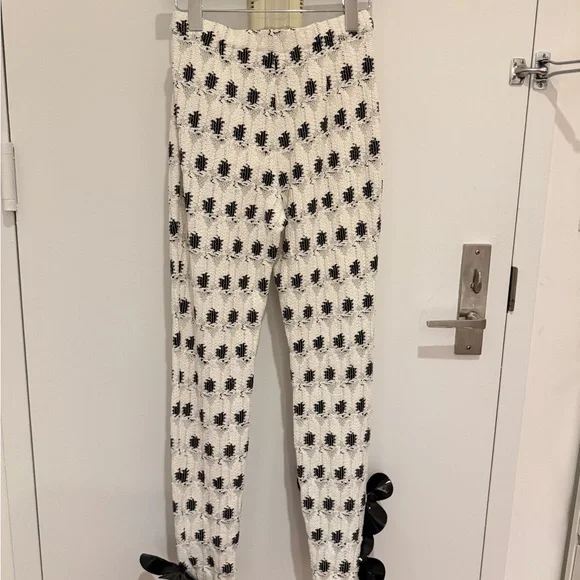 AREA eye crochet knit pants featuring crystal flower applique
